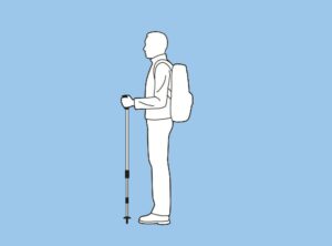 A person with a backpack and walking stick